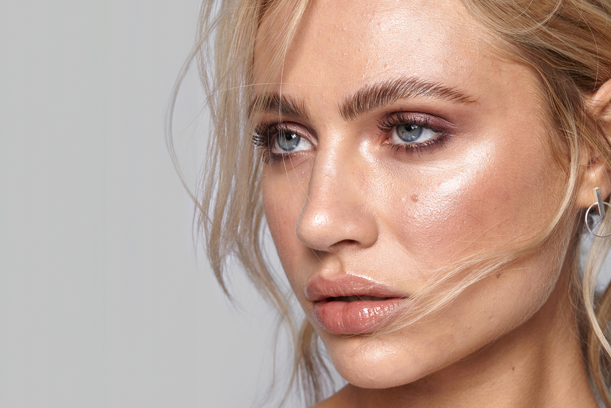 Close-up of a woman's perfectly laminated eyebrows, showcasing a brow lamination service for fuller and defined brows. Ideal for enhancing natural beauty and achieving a long-lasting, polished look.